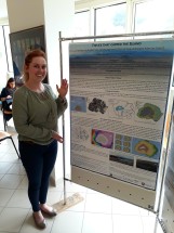 Liezel standing by her poster, which focused on her PhD research.